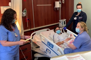 Members of the Labor and Delivery team conduct a simulation going through the steps to respond to a postpartum hemorrhage.